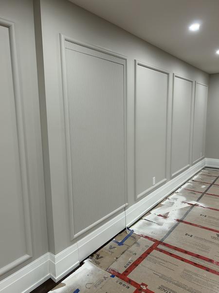 Hallway with painted wainscoting and a fluted panel
