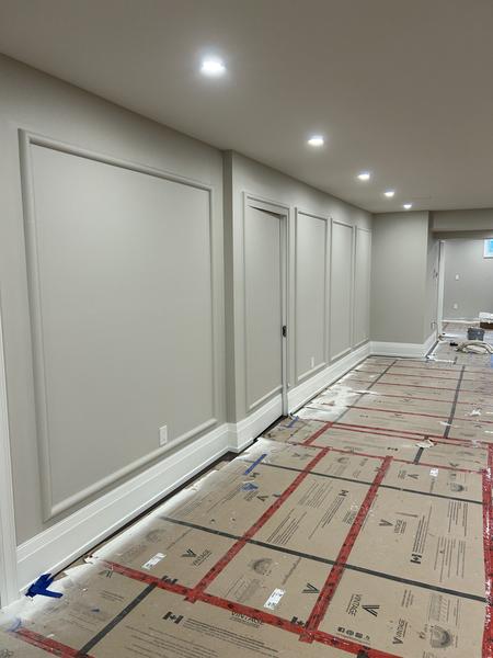 Long hallway with painted picture-frame wainscoting