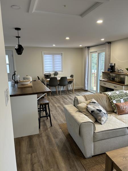 Finished open-concept living room and kitchen with walnut counter