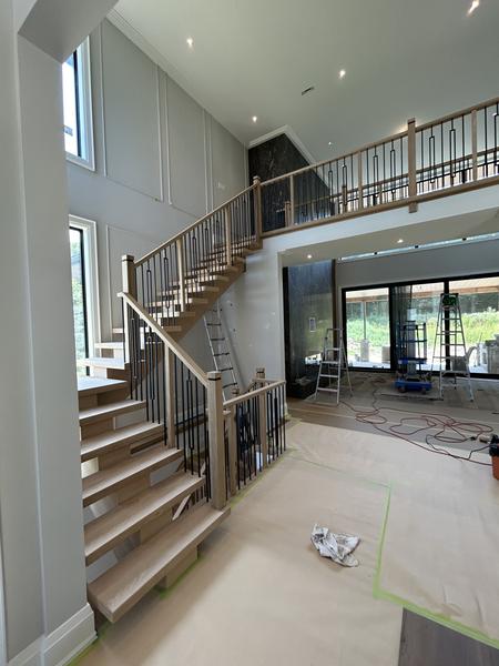 Open-riser oak staircase in a two-storey foyer