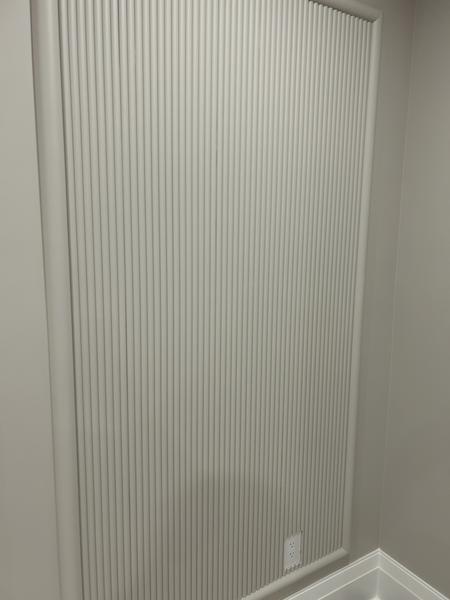 Painted fluted feature wall panel in soft grey-white