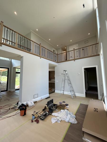 Two-storey great room with oak and black iron balcony railing